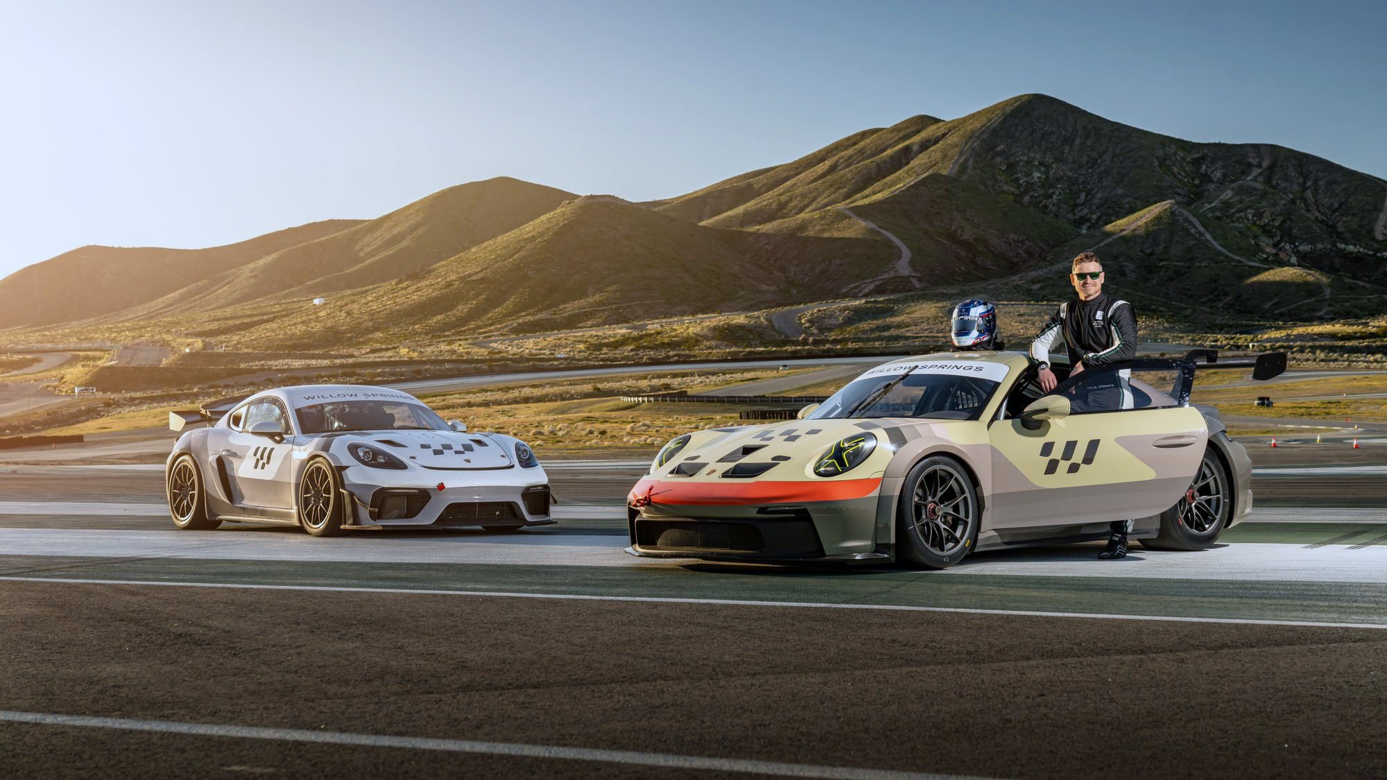 Alex Waters beside a Porsche 911 GT3 Cup car and a 718 GT4 at Willow Springs