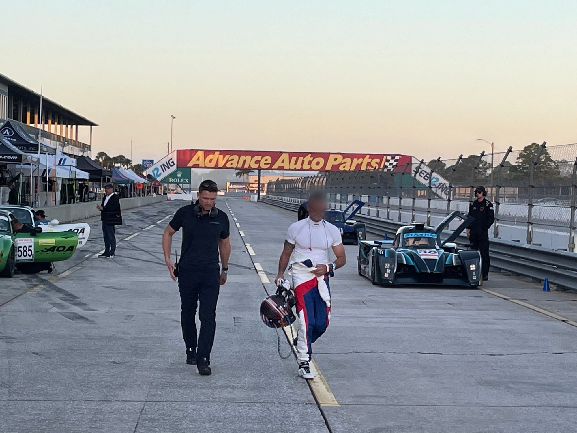 Alex Waters walking the Sebring pit lane with a client driver after a session